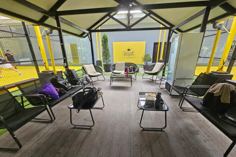 Lounge inside the pavilion with timber floors and outdoor chairs